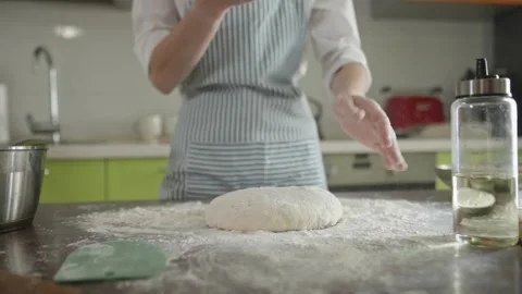 Chef is kneading dough with her hands in the kitchen for making pizza Stock Footage 280167886
