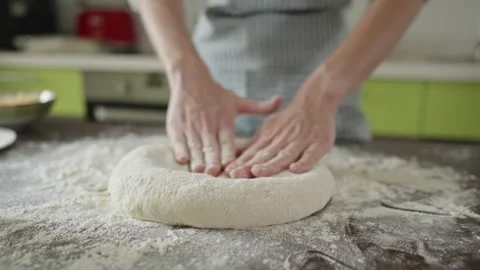 Chef is kneading dough with her hands in the kitchen for making pizza Stock Footage 280168168