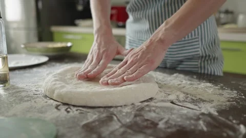 Chef is kneading dough with her hands in the kitchen for making pizza Stock Footage 280168853