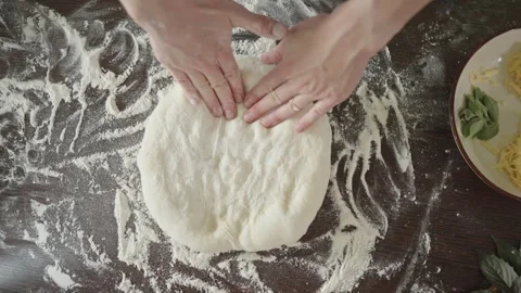 Chef is kneading dough with her hands in the kitchen for making pizza Stock Footage 280169169