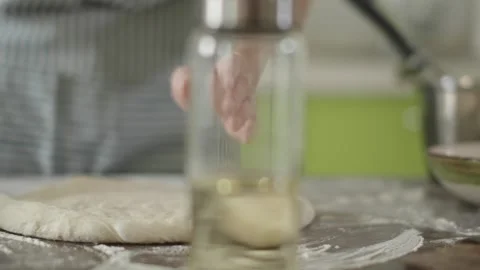 Chef is kneading dough with her hands in the kitchen for making pizza Stock Footage 280169345