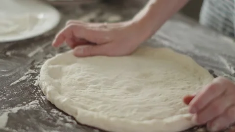 Chef is kneading dough with her hands in the kitchen for making pizza Stock Footage 280169425