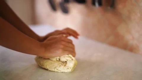 Chef kneading white dough with her hands on the table Stock Footage 268452079