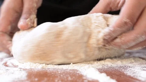 Chef kneads bread dough on the table Stock Footage 113353912