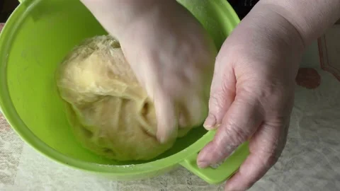 The chef kneads the dough with his hands Stock Footage 166707423