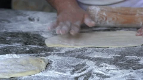 Chef kneads the dough on the table with his hands Stock Footage 138522896