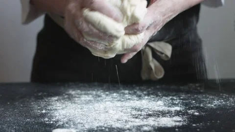 Chef kneads a large dough piece Stock Footage 74338892