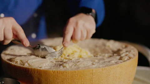 Chef Kneads Pasta Inside Large Circle Of Parmesan Cheese. Stock Footage 262727629