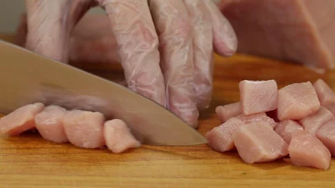 Chef with a knife cuts strips of meat Stock Footage 122119010