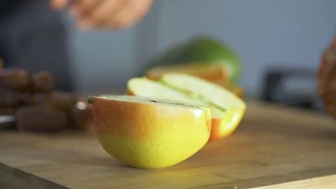 Chef with knife cutting apple on chopping board in kitchen Stock Footage 85814704