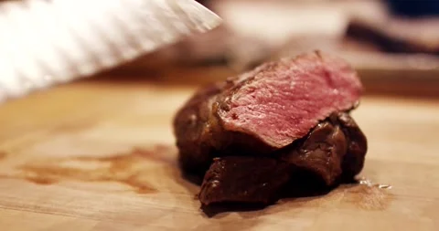 Chef Knife Cutting Medium Rare Steak on Board, Steakhouse Kitchen, Close Up Stock Footage 340322689