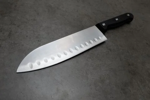 Chef knife on a dark gray table Stock Photos