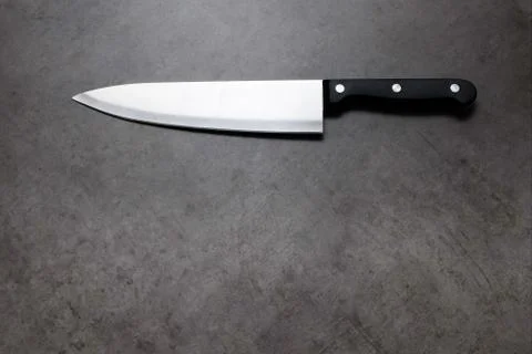 Chef knife on a dark gray table Stock Photos