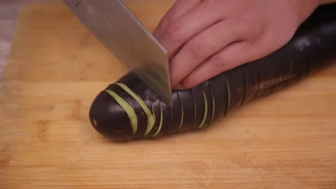 Chef knife demonstrates coir raincoat eggplant with knife eggplant (3) Stock Footage 202169256