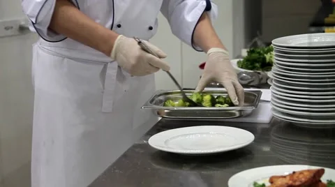Chef lay (broccoli) cauliflower on a plate. Cooking on kitchen Stock Footage 55694110