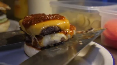 Chef Lifting Freshly Smashed Double Cheeseburger with Spatula Video stock 347687745