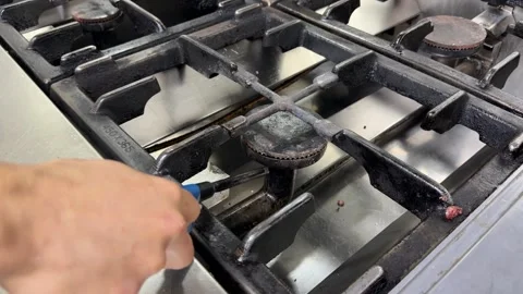 Chef lighting a gas stove and heating a frying pan Video stock 344100110