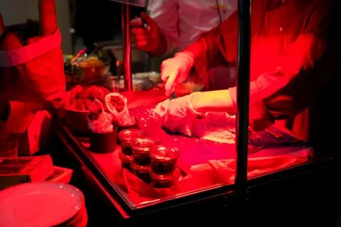 Chef live cooking preparing fish fillet in salt crust Stock Photos