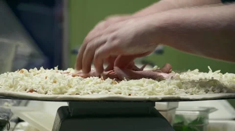 Chef Loading Pizza with Ham and Pepperoni Stock Footage 22251410