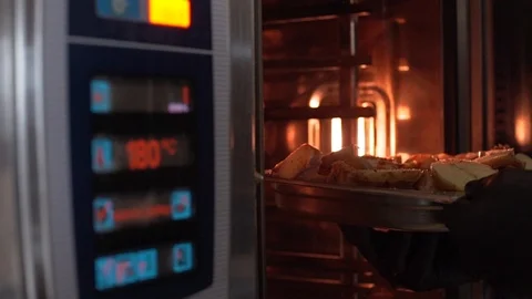 The chef loads the oven in the chicken Video stock 127561068