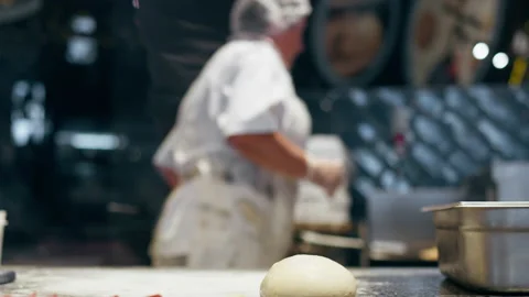 The chef loads puts the pizza with a culinary shovel into the burning red-ho Stock Footage 203015306