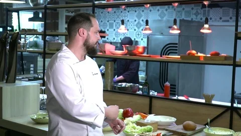 Chef looking to the camera and sending kiss slow motion Stock Footage 77043424