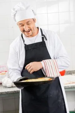 Chef Looking At Fresh In Pan 写真素材