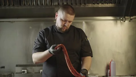 The chef is looking at raw ribs marinated ribs. Video stock 236382585