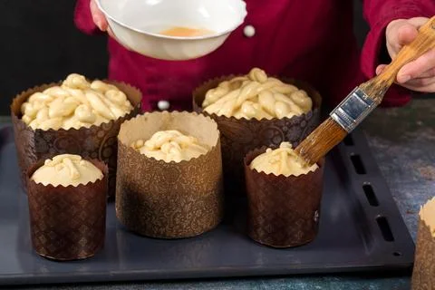 The chef lubricates the surface of the Easter cake with egg mixture 库存照片