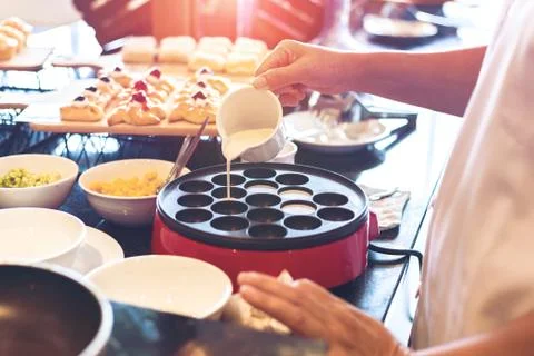 The chef make the dessert on the table and pour coconut milk. Stock Photos