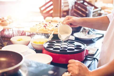 The chef make the dessert on the table and pour coconut milk. Stock Photos
