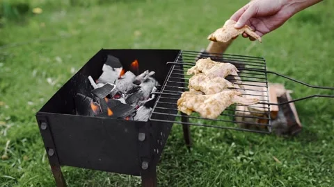 Chef makes BBQ with chicken wings on the hot coals of the grill outdoors Stock Footage 89683999