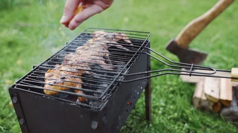 Chef makes bbq on the hot coals of the grill Stock Footage 143778410