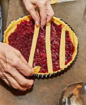 Chef makes cherry pie in his home kitchen Stock Photos