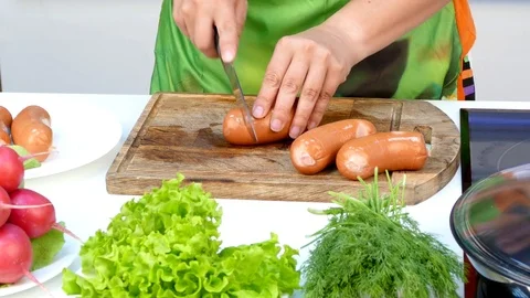 The chef makes cuts on sausages Stock Footage 84559896