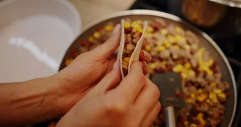 A chef makes delicious tacos in a pan, showcasing vibrant colors Stock Footage 307934501