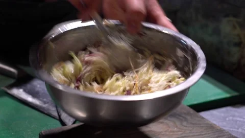 The chef makes a meat salad. He stirs the meat salad in a cup. Restaurant Stock Footage 171682411