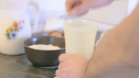 Chef makes a mixture of pancakes with flour, egg and milk Video stock 75807191