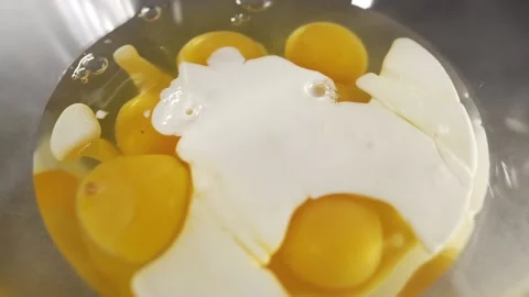 Chef makes omelet raw eggs and cream teasty breakfast Stock Footage 143778541