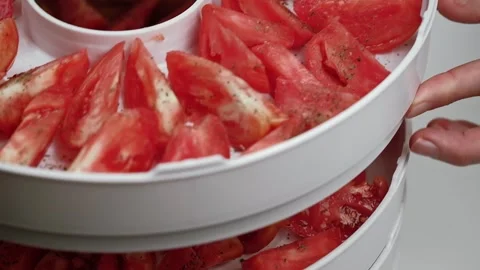 Chef makes pallets with tomatoes, for drying in the vegetable dryer. closeup. Stock Footage 253650770