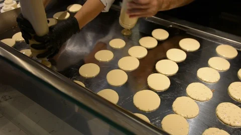 The chef makes Pancakes for breakfast at the buffet restaurant. The process of m 스톡 동영상 106349944