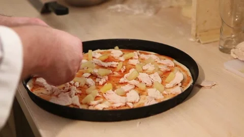 Chef makes pizza. The cook makes pizza with pineapple, Italian pizza, the hands Stock Footage 87323650