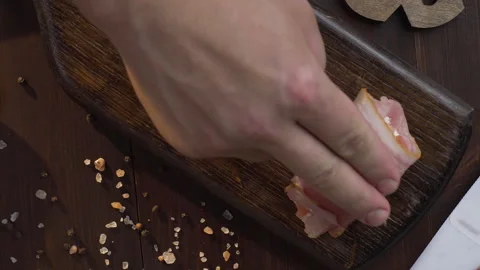 Chef makes rolls with bacon and chicken chest on the dark wooden board Stock Footage 143778736