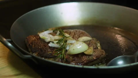 Chef makes tasty beef steak in the iron pan Stock Footage 165482106