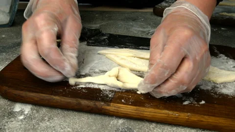 Chef makes from twisted slice dough. Vídeo Stock 132355059