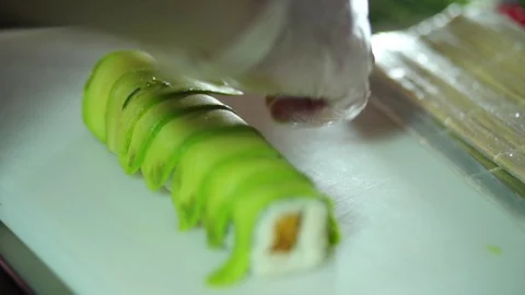 Chef making avocado sushi on white table Video stock 106389083