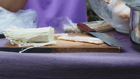 The chef is making bacon wrapped in golden needle mushroom for evening party. Stock Footage 112712964