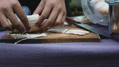 The chef is making bacon wrapped in golden needle mushroom for evening party. Stock Footage 122667147