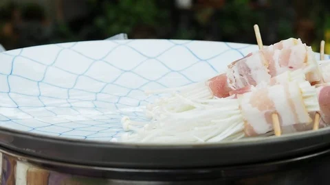 The chef is making bacon wrapped in golden needle mushroom for evening party. Stock Footage 124771054