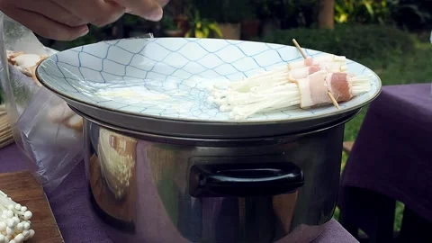 The chef is making bacon wrapped in golden needle mushroom for evening party. Stock Footage 137409982